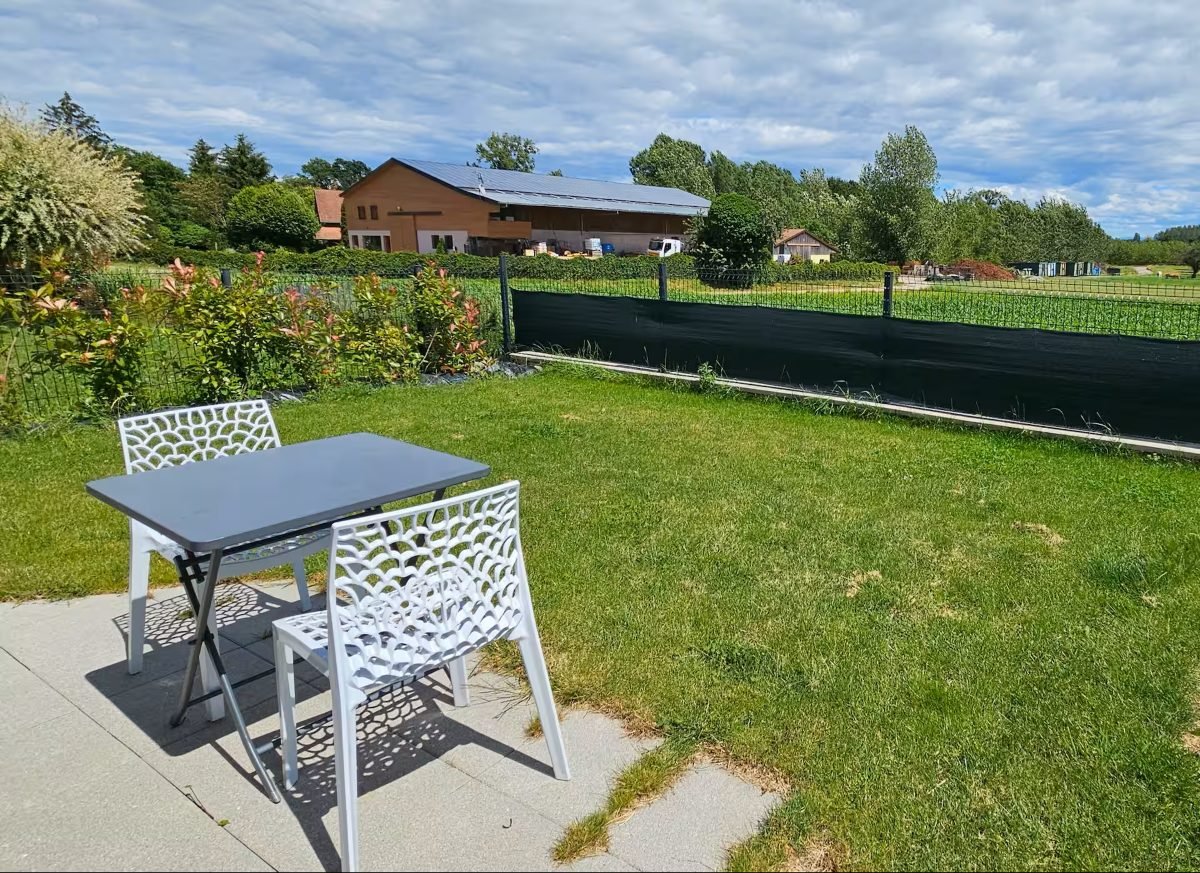 Le jardin engazonné du studio d'Osthouse, ouvert sur la campagne alsacienne